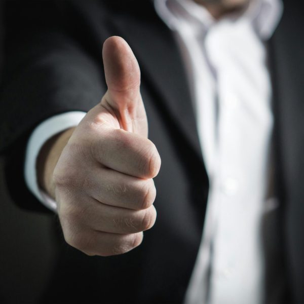 pexels-photo-327533-327533 A close-up of a man's thumbs up gesture, symbolizing success and agreement.
