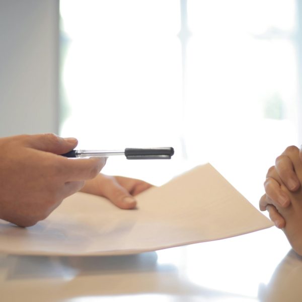 pexels-photo-3760067-3760067 Close-up of a contract signing with hands over documents. Professional business interaction.